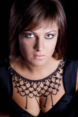 portrait of brunette girl in a black satin dressの写真素材