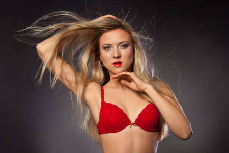 blonde girl with hair vrazlet posing in the studioの写真素材