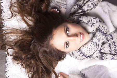 young woman with a scarf around his neck, his hair disheveledの写真素材