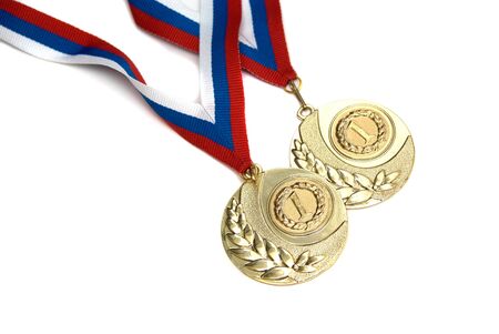 Two golden medals isolated on whiteの写真素材