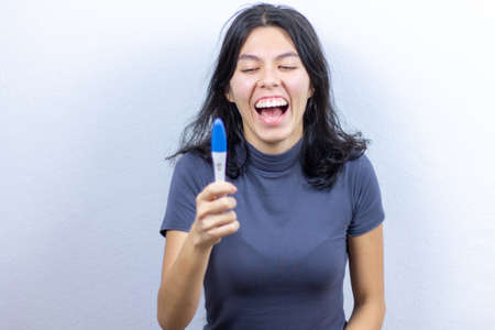 Happy girl with positive pregnancy testの写真素材