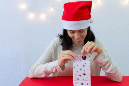 Girl with a Christmas present. Advent calendar, day 24の写真素材