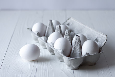 white eggs on white wooden background