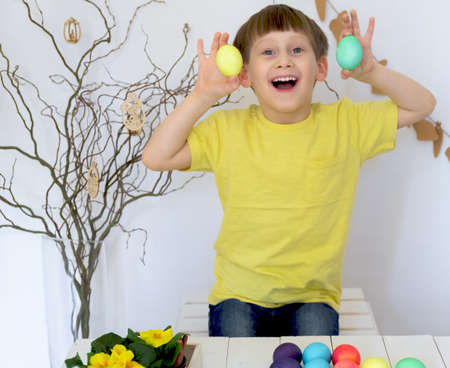 Little boy holding Easter eggs in his hand