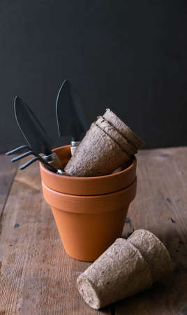 Garden tools, flower pots on wooden backgroundの写真素材