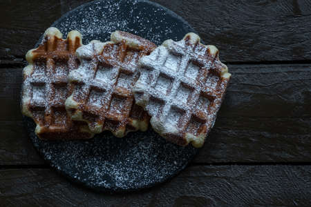 Belgian waffles on a wooden tableの写真素材