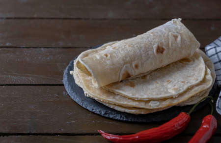 Tortillas on wooden table. Mexican breadの写真素材