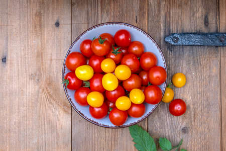 ripe tomatoes on a wooden tableの写真素材