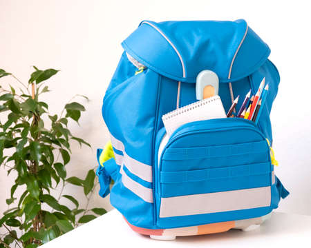 Classic colored school backpack with supplies. Preparation for school. Back to schoolの写真素材
