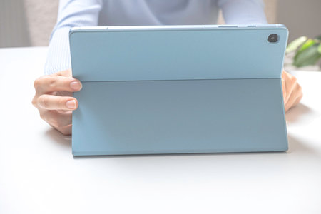 Close-up image of young professional female manager using laptop at her office, businesswoman...