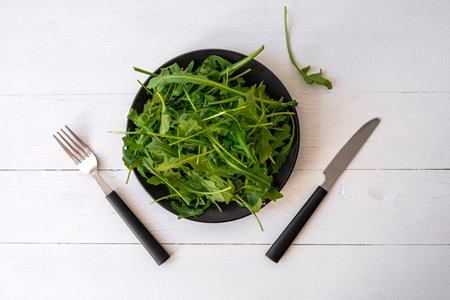 fresh arugula on white table