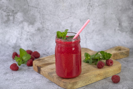 Raspberry smoothie in a jar on a gray concrete backgroundの写真素材