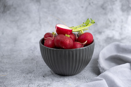 fresh radish in a plate on a gray backgroundの写真素材