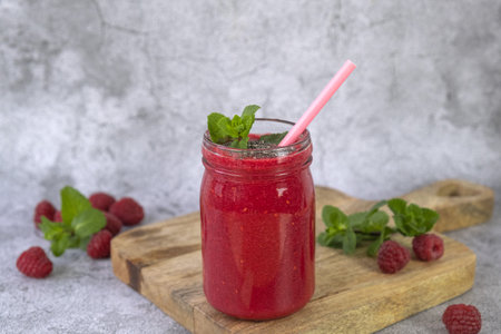 Raspberry smoothie in a jar on a gray concrete backgroundの写真素材