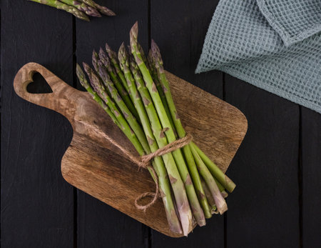 banches of fresh green asparagus on wooden background, top viewの写真素材