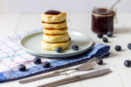 Syrniki or cottage cheese fritters with blueberry jam. Traditional Ukrainian breakfastの写真素材