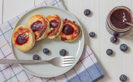 Syrniki or cottage cheese fritters with blueberry jam. Traditional Ukrainian breakfastの写真素材