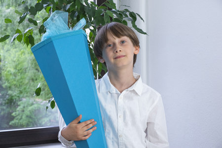 Happy child holding traditional German candy cone on the first school day.の写真素材