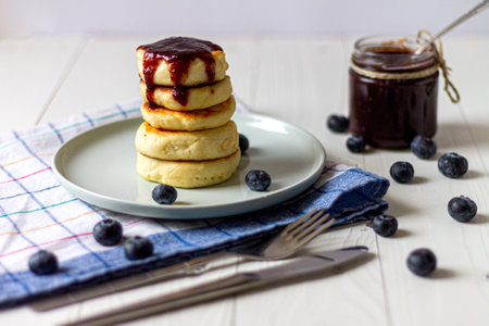 Syrniki or cottage cheese fritters with blueberry jam. Traditional Ukrainian breakfastの写真素材