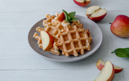 Waffles with apples on a plateの写真素材