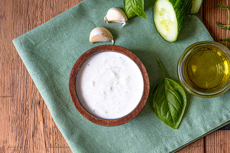 White dip sauce - sour cream or yogurt in wooden bowl. Greek sauceの写真素材