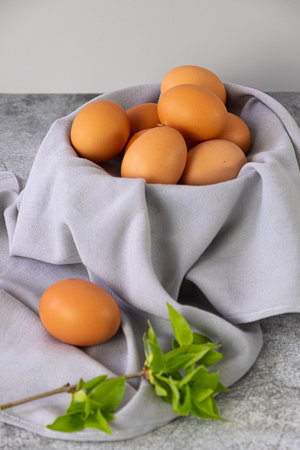 Brown eggs on gray napkin. Vertical photoの写真素材