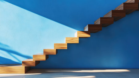Calm stairway scene with daylight washing over wood stairs and blue paintの素材