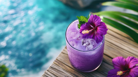 Tropical-themed purple cocktail garnished with hibiscus flowers on a cozy beach deckの素材