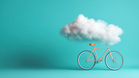 Surreal floating bike beneath a single cloud on cyan blue backgroundの素材