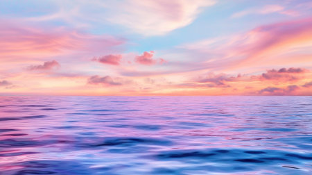 Tranquil ocean water reflecting soft pink and peach sunset colors, peaceful beach settingの素材