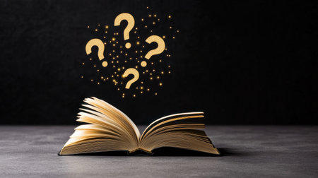 Conceptual shot of an open book with question marks above, symbolizing inquiry and thought, black backgroundの素材