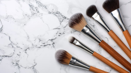 A stunning arrangement of high-quality makeup brushes sits elegantly on a smooth marble surface, perfect for beauty and cosmetic photography or marketing.の素材