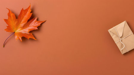 This image captures the essence of autumn with an orange maple leaf beside a beautifully wrapped gift, set against a warm brown background. Perfect for seasonal promotions.の素材