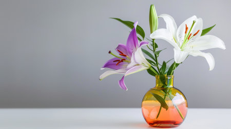 This stunning image showcases an elegant arrangement of colorful lilies in a modern glass vase, adding a touch of beauty and freshness to any space.の素材