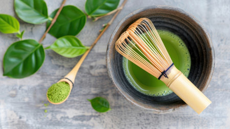 Capture the essence of traditional matcha tea preparation with a bamboo whisk, vibrant green bowl, and lush green leaves, showcasing natural wellness and serenity.の素材
