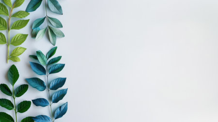 A beautifully arranged collection of vibrant green and blue leaves resting on a light background, ideal for creative projects, nature themes, and design inspiration.の素材