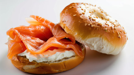 A close-up view of a smoked salmon bagel, featuring tender slices of salmon atop smooth cream cheese on a sesame seed bagel, ideal for flavorful meals.の素材