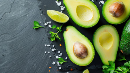 A vibrant display of fresh avocado halves accompanied by lime wedges and sea salt, showcasing healthy eating and cooking inspiration in a captivating setting.の素材