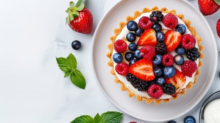 A stunning dessert featuring a round tart filled with creamy goodness and topped with an array of fresh berries, perfect for summer celebrations.の素材