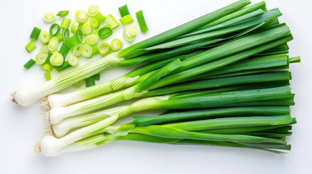 This image showcases a bunch of fresh green onions alongside sliced pieces, highlighting their vibrant color and texture, perfect for culinary uses.の素材