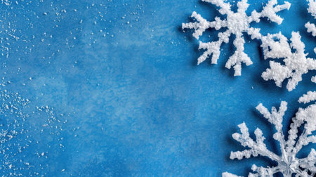This image features stunning white snowflakes beautifully layered on a vivid blue background, adding charm and elegance to winter and holiday themes.の素材