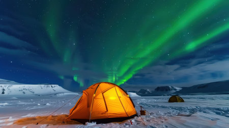 A breathtaking view of an orange tent illuminated under the stunning aurora borealis in a snowy landscape, surrounded by a star-filled night sky.の素材
