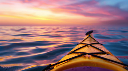 A stunning view from a kayak gliding over calm waters, showcasing a vibrant sunset sky filled with colorful hues, inviting peaceful reflection.の素材