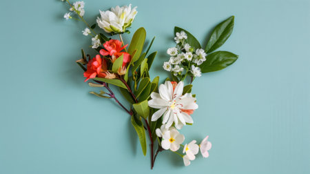 A stunning floral arrangement featuring a variety of vibrant flowers on a soft light blue background, perfect for showcasing nature's beauty and creativity.の素材