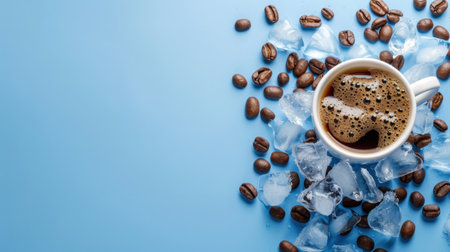 A beautiful cup of cold brew coffee served with ice cubes and scattered coffee beans on a light blue background, perfect for summer refreshment.の素材