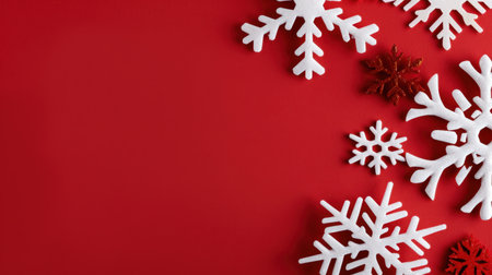 This image showcases beautiful white snowflakes arranged on a vibrant red background, perfect for winter season decorations and holiday celebrations.の素材