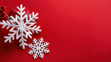 Capture the essence of winter with white snowflakes resting on a vibrant red background. Ideal for holiday designs and festive decorations, this image exudes a cheerful and warm atmosphere perfect for seasonal celebrations.の素材