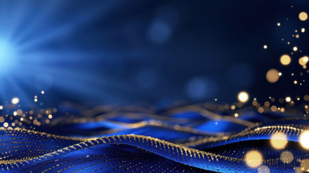 This stunning abstract image features blue waves with shimmering golden sparkles, illuminated by radiant light, creating a serene and enchanting atmosphere.の素材