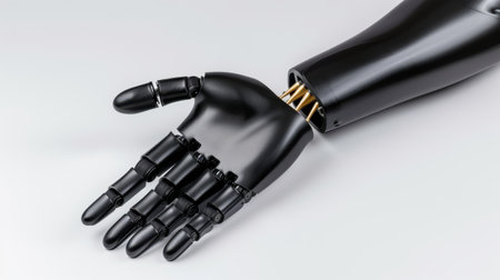 A detailed view of a robotic prosthetic hand with a sleek black design, highlighting its advanced features aimed at enhancing user comfort and functionality.の素材