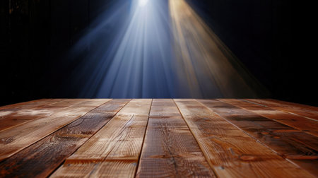 A stunning wooden table surface with intricate textures contrasted by dramatic light rays shining down in a dark setting, creating a warm and inviting atmosphere.の素材